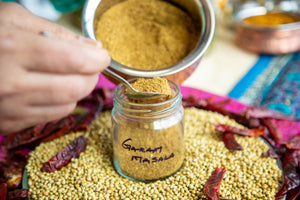 Garam Masala being added to jar.