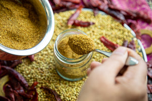 Garam Masala being added to jar.