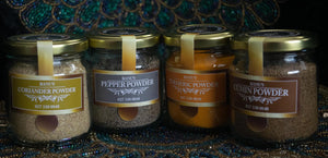 Selection of 4 spice powders. Coriander Powder, Pepper Powder, Tumeric Powder, Cumin Powder